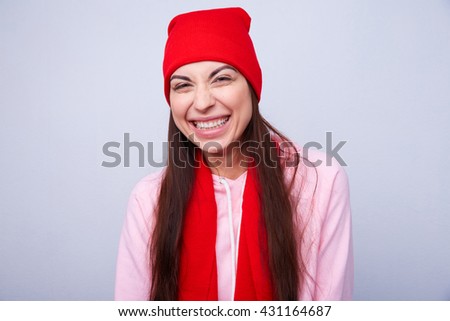girl in a red hat and scarf smiling