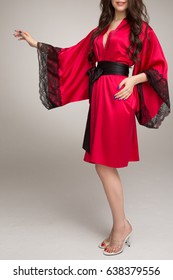 Girl In Red Silk Robe, On Gray Background