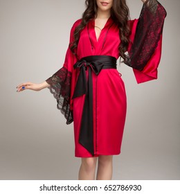 Girl In Red Silk Robe, On Gray Background