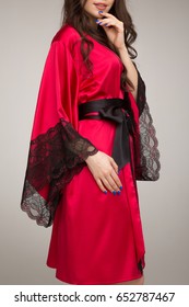 Girl In Red Silk Robe, On Gray Background