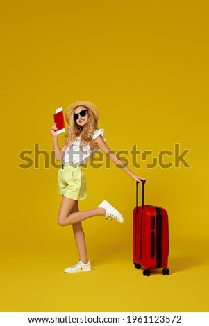 girl with red suitcase and passport with ticket going traveling