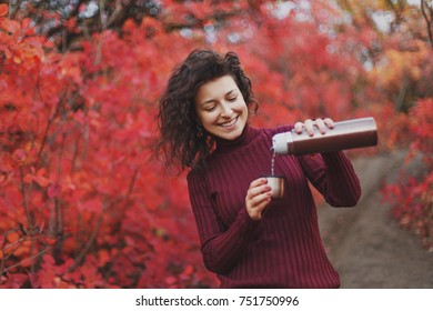 Girl In Red Sweater Pours Tea From Thermos