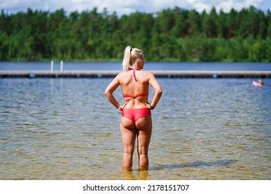 A Girl In A Red Swimsuit At The Palojärv Forest Lake, Rear View.