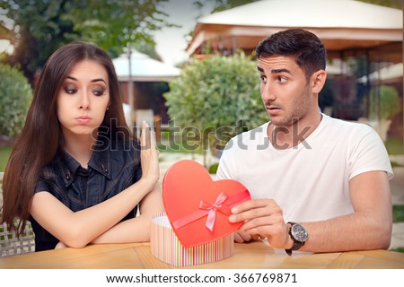 Girl Refusing Heart Shaped Gift From Her Boyfriend - Materialist girlfriend refusing a present from her loved one
