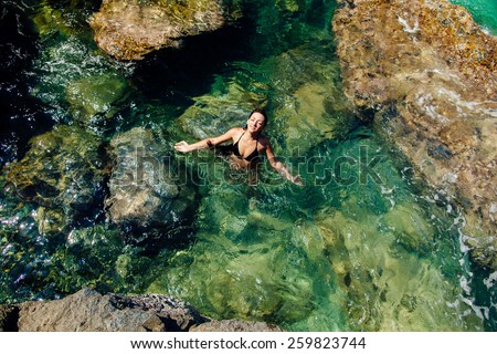 girl relax in blue sea lagoon in asia  aerial top view