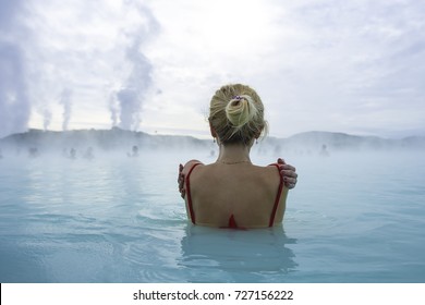 Girl relaxing in the Blue lagoon. Iceland. She looks into the distance - Shutterstock ID 727156222