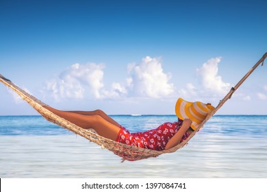 Girl Relaxing In A Hammock On Tropical Island Beach. Summer Vacation In Punta Cana, Dominican Republic.