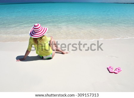 Girl relaxing on the beach of Great Exuma, Bahamas