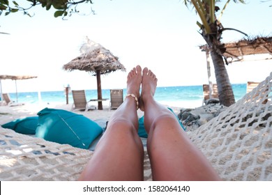 Girl Relaxing On A Hammock On Beautiful Sandy Beach Of Fiji, View On Her Legs