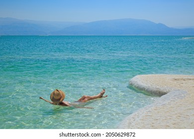 Girl Relaxing In The Water Of Dead Sea