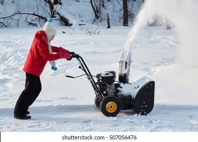 Girl Removes Snow With Gas Snow Thrower At Winter Day.