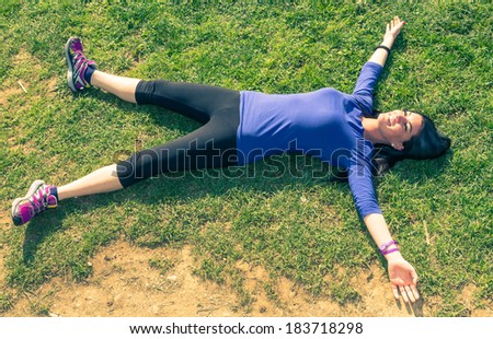 girl rests on the grass after long run