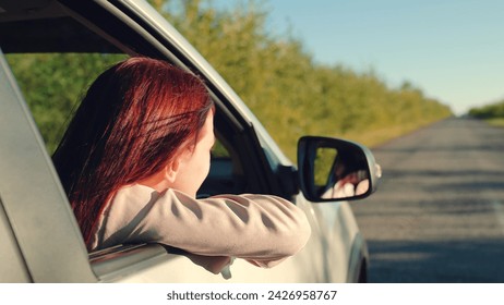 girl rides car with her hand out window, sun glare sunset driver hand leans out window, happy family, traveling with friends sunny day, girl sits car looks out window sunny day, car driving, adventure - Powered by Shutterstock