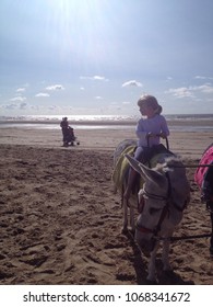 Girl Rides Donkey On The Beach At Blackpool