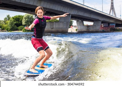 Girl Rides A Study Wakesurfing