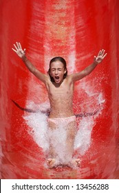 Girl Riding Down A Waterslide