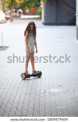 Girl riding a hoverboard in the city