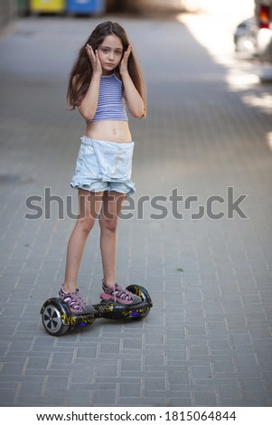 Girl riding a hoverboard in the city