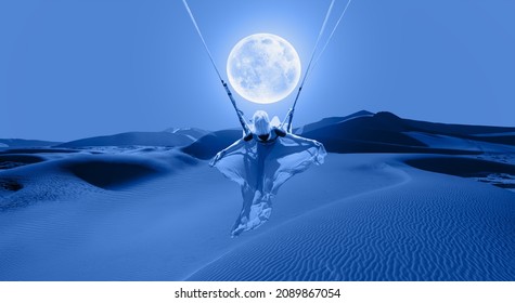 The girl riding a swing on the space on a full moon at night 