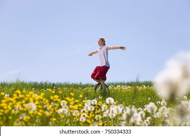 Girl Riding Unicycle Through Meadow