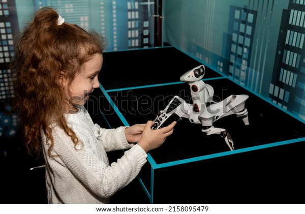 A girl at a\
robot show. Technology.\
Future.