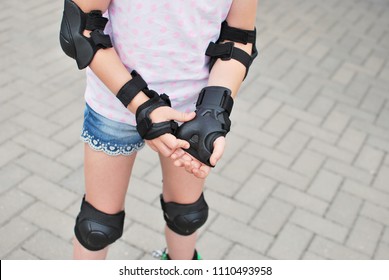 Girl Roller Skater With Safety Equipment - Knee And Elbow Pads, Wrist Guard. Safe Summer Activity. Kids Activity.