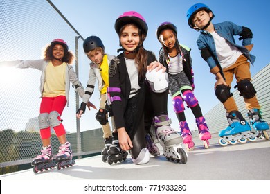 Girl in rollerblades playing with friends outdoors
