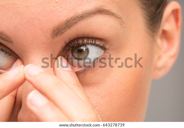 Girl rubbing her\
eyes