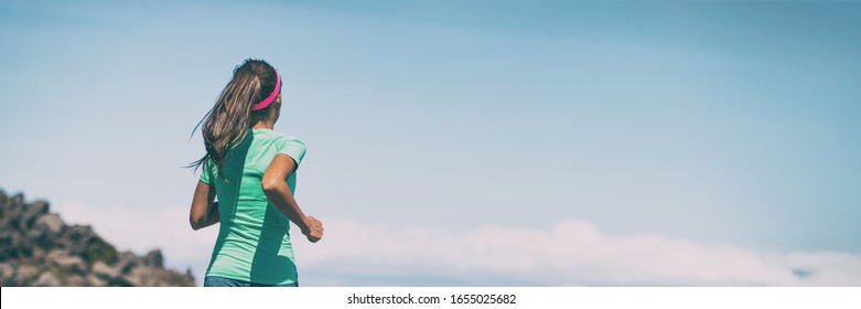 Girl Runner Running On Trail Run Outdoor Summer Landscape In Mountains Header Panoramic Of Blue Sky Background . Female Athlete Woman Training Cardio Outside Wearing Headband And Ponytail.