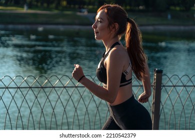 Girl Running Around The Lake In The Park