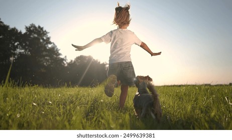 girl running with dog on the grass in the park. happy family childhood dream concept. the dog runs next to the little girl. child and his pet have fun together in the park on the grass lifestyle - Powered by Shutterstock