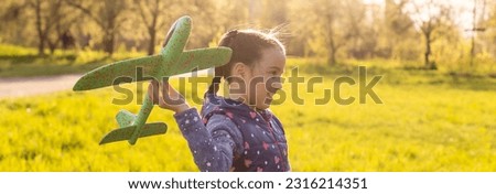 Girl running fast and holding airplane toy