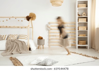 Girl running in a scandinavian style bedroom