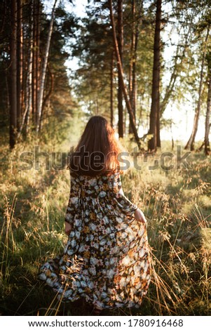 Similar – Image, Stock Photo Young woman with hat taking a walk in the deep forest at sunset.