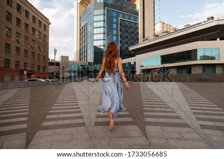 girl runs away in the city.  blurred background. 