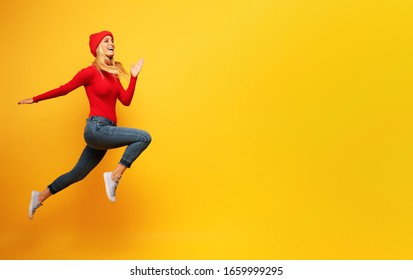 Girl runs fast. concept of energy and vitality.yellow background