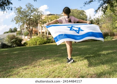 Girl Runs Joyfully Holding Israeli Flag In A Kibbutz Setting. - Powered by Shutterstock