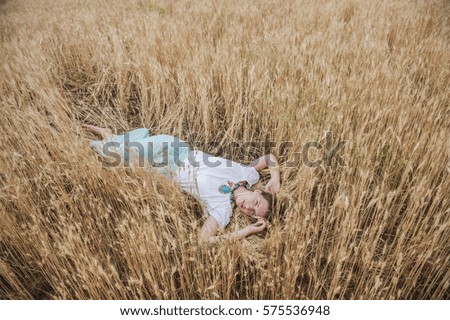 Similar – Foto Bild Junge Frau ruht auf einem Weizenfeld.