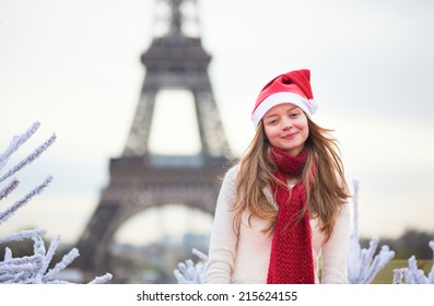 Girl In Santa Hat Near The Eiffel Tower In Paris During Christmas Time