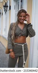 A Girl In A Scarf With Beautiful Long Dreadlocks And Jewelry Walks On The Street. Stylish Hippie Girl In Boho Clothes Dances And Laughs. Boho Style, Gypsy, Street Style, Travel