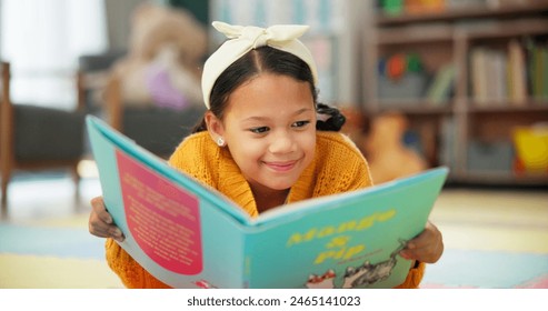 Girl, school and reading book in class, childhood development and growth for vocabulary in kindergarten. Happy, smile and knowledge or information with storybook, learning and fantasy for child - Powered by Shutterstock