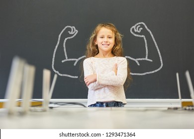 Girl in school is standing in front of blackboard - Shutterstock ID 1293471364