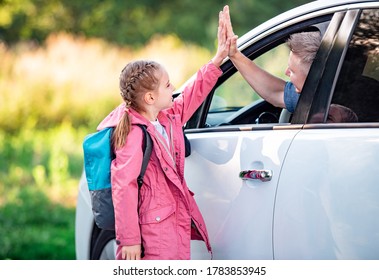 Girl Schooler Giving Five To Father Sitting In Car