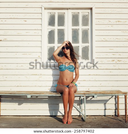 Surfer woman with top and bikini holding surfboard