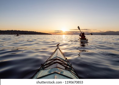 Girl Sea Kayaking During A Vibrant Sunny Summer Sunset. Taken In Vancouver, BC, Canada.