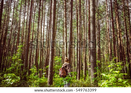 Similar – Image, Stock Photo Young woman with hat taking a walk in the deep forest at sunset.