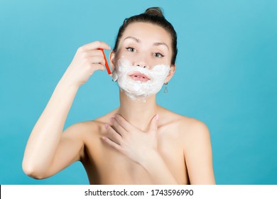 Girl Shaving Her Face With A Disposable Razor Using Shaving Foam. Close Up