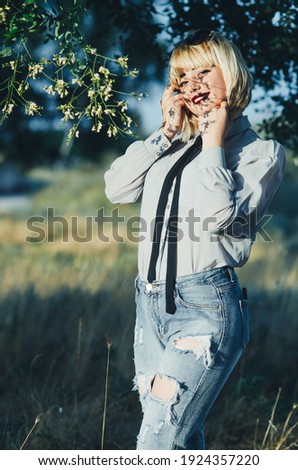 Similar – Woman with sunglasses touching over nature background