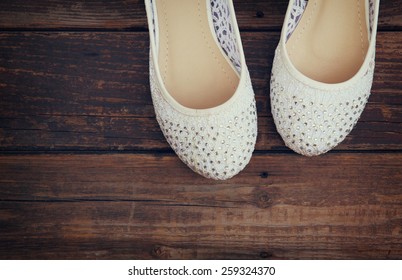 Girl Shoes Over Wooden Deck Floor. Filtered Image.
