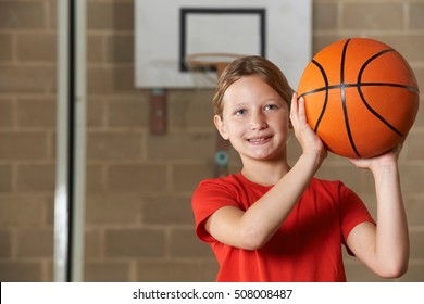 Girl Shooting Basketball In School Gym